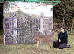 Anandamayi with deer in front of mural